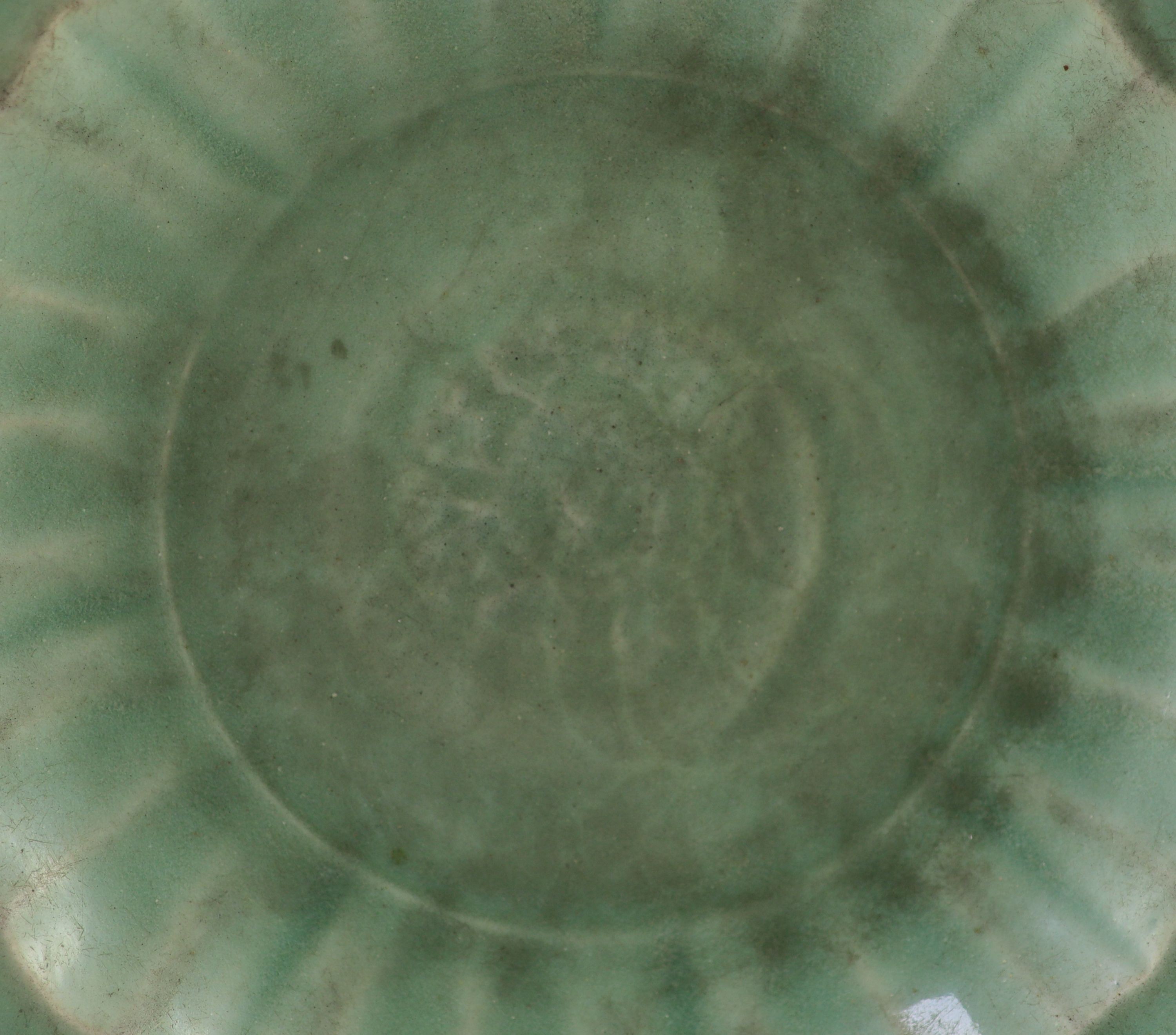 A Chinese Ming Longquan celadon dish, 15th/16th century, 30.5 cm diameter, glaze worn